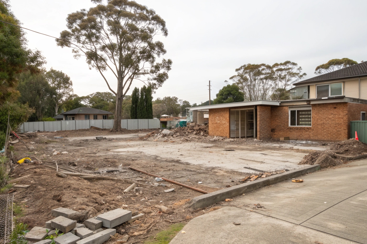 Cleared site after professional concrete demolition showing clean leveled ground